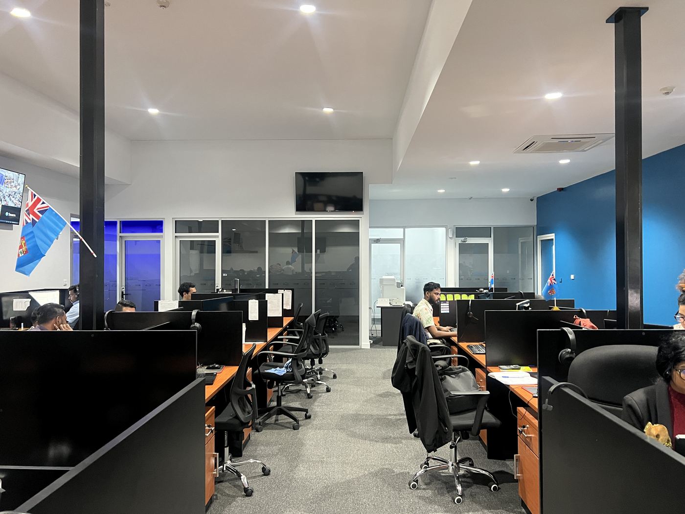 Dual-monitor, headset-equipped workstations, NexOutsource office, Suva